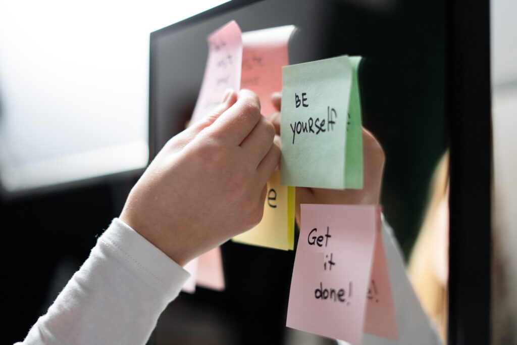 Post-it notes with affirmations written on them and placed on a board